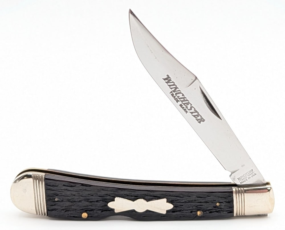 1988 Winchester Jigged Bone Large Trapper 1950: Knife is in good condition with scuffs and tarnishing on the bolsters, and a bad crack on the front handle scale. Overall measures 5-3/8in when closed.