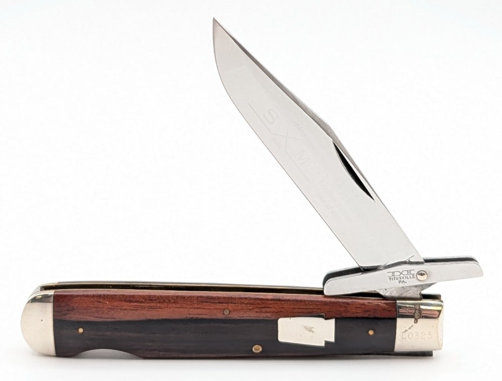 Ltd 1993 Schatt & Morgan ABCA Smooth Wood Swing Guard Knife: Knife is numbered L0323 of 600, and is in nice condition with light scuffs and tarnishing from handling and age. Overall measures 4-1/2in when closed.