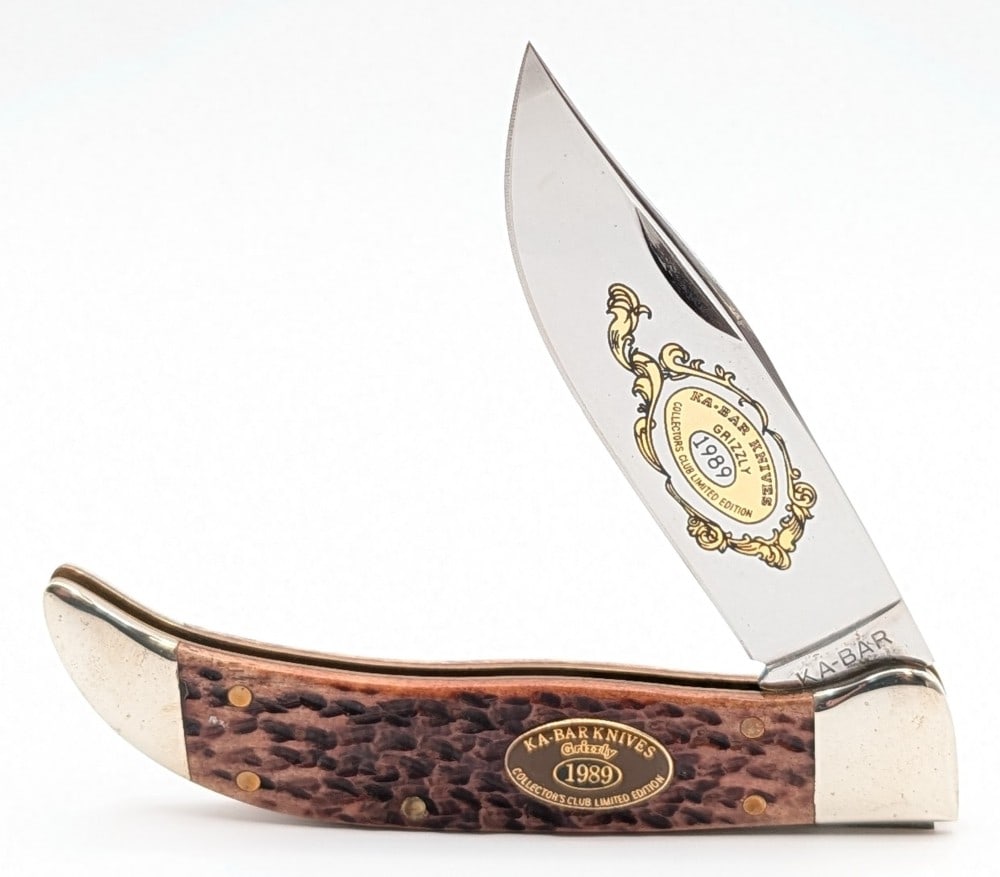 Ltd 1989 Ka-Bar Collectors Club Jigged Bone Grizzley: Knife is numbered 5466, and is in good condition with light scuffs and tarnishing on the bolsters from handling and age. Overall measures 5-3/8in when closed.
