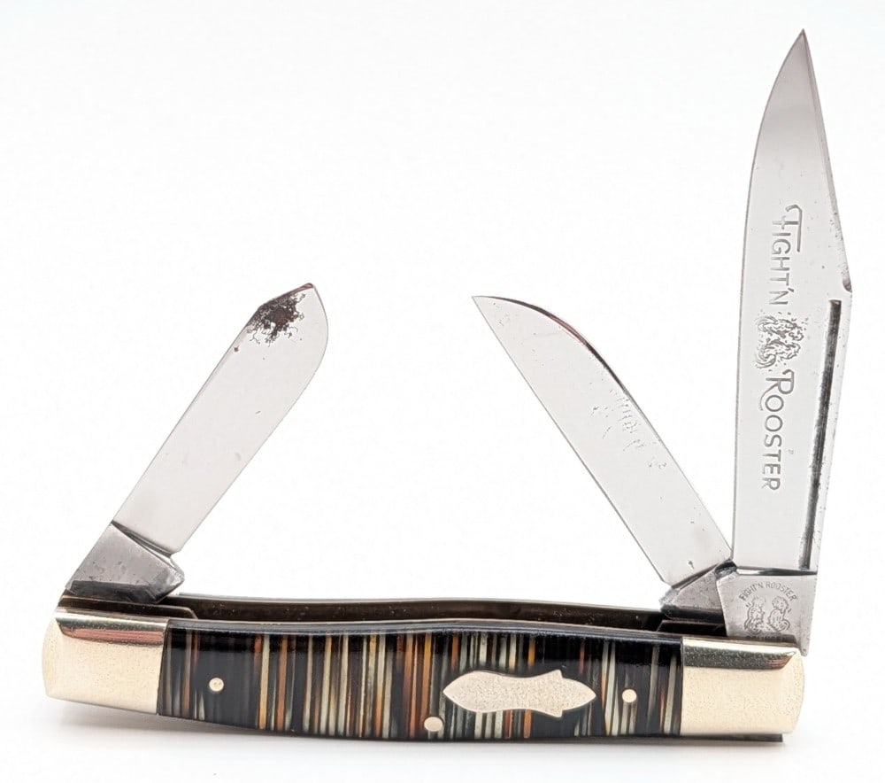 Fight'n Rooster Frank Buster Celluloid Stripe Stockman: Knife is in good condition with carbon spotting on the blades, and light tarnishing and scuffs on the bolsters. Overall measures 3-3/4in when closed.