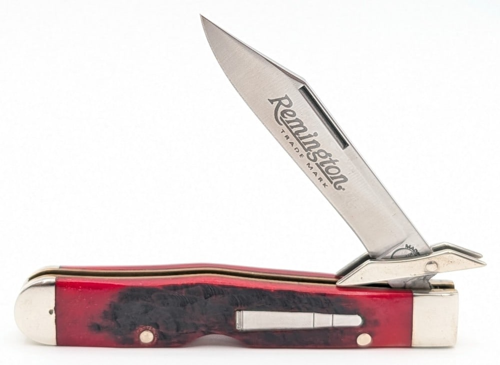 2007 Remington Red Bone Swing Guard Cheetah R1373: Knife is in very nice condition with light scuffs and tarnishing on the bolsters from handling. Overall measures 4-3/8in when closed.