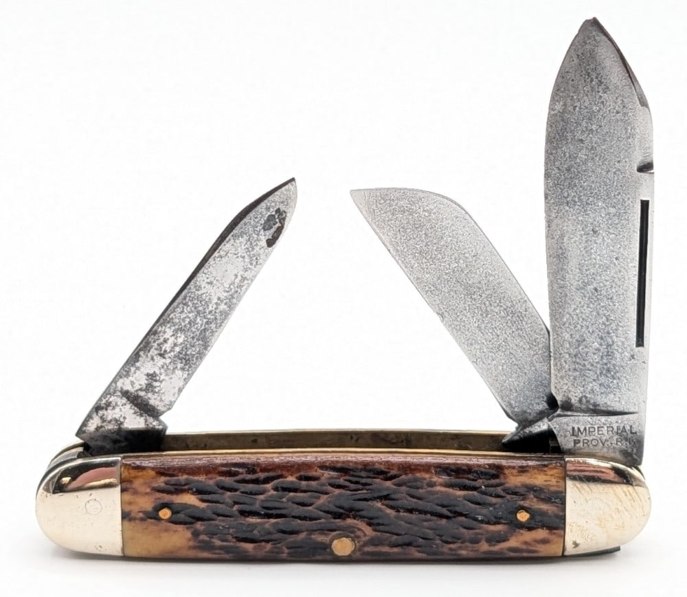 Imperial Jigged Bone Even End Stockman: Knife is in nice aged condition with some scratches and pitting on the blades, scuffs and tarnishing on the bolsters, and nice handle scales. Overall measures 3-3/4in when closed.