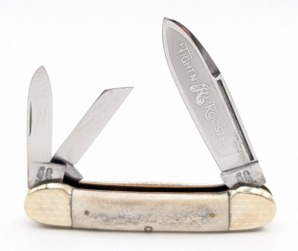 Frank Buster Fight'n Rooster Engraved Stag Canoe Knife: Knife is in nice condition with some tarnishing on the blades from age. Overall measures 3-5/8in when closed.