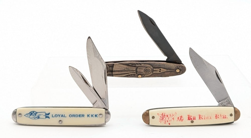 Various Brand Ku Klux Klan Synth White & Brass Advertising Knives: Two of the knives are unmarked, and the one is marked Flying Falcon. Knives are in good condition with some scuffs and scratches from handling and age. Overall measures 3-3/8in when closed.