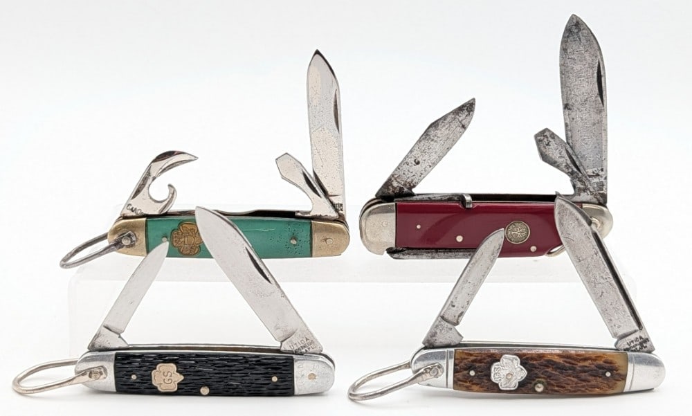 Vtg Utica, Kutmaster, & Boker Scout & Camp Knives: Knives are in fair aged condition with scratches and tarnishing on the blades and bolsters, and other scuffs and wear from use and age. Largest overall measures 3-1/2in when closed.