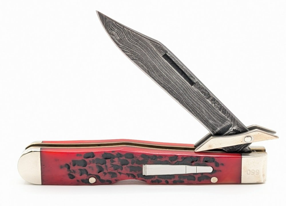 Ltd 2007 Remington Damascus Red Bone Cheetah R1373-D: Knife is numbered 099, and is in very nice condition with light tarnishing on the bolsters from handling. Overall measures 4-3/8in when closed.