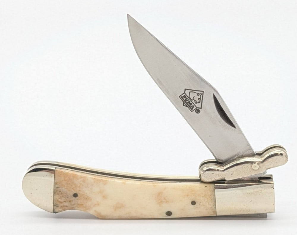 Puma Smooth Bone Medici Swing Guard Folding Knife 21 0563: Knife is in very nice condition with light scuffs on the bolsters from handling. Overall measures 3-1/2in when closed.