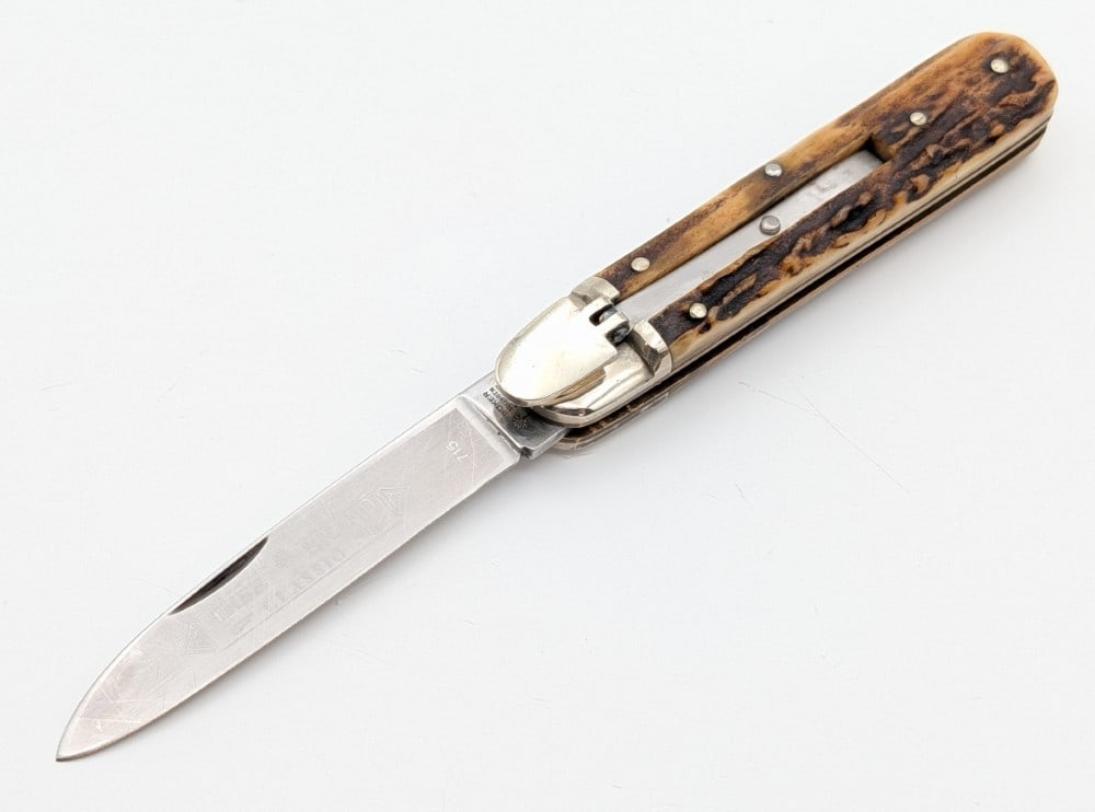 Boker Tree Brand Stag Leverlock Switchblade 715: Knife is in good used condition with scratches on the blade, and light scuffs and dings on the bolsters from use and handling. Spring is nice and strong and locks tight when open. Overall measures