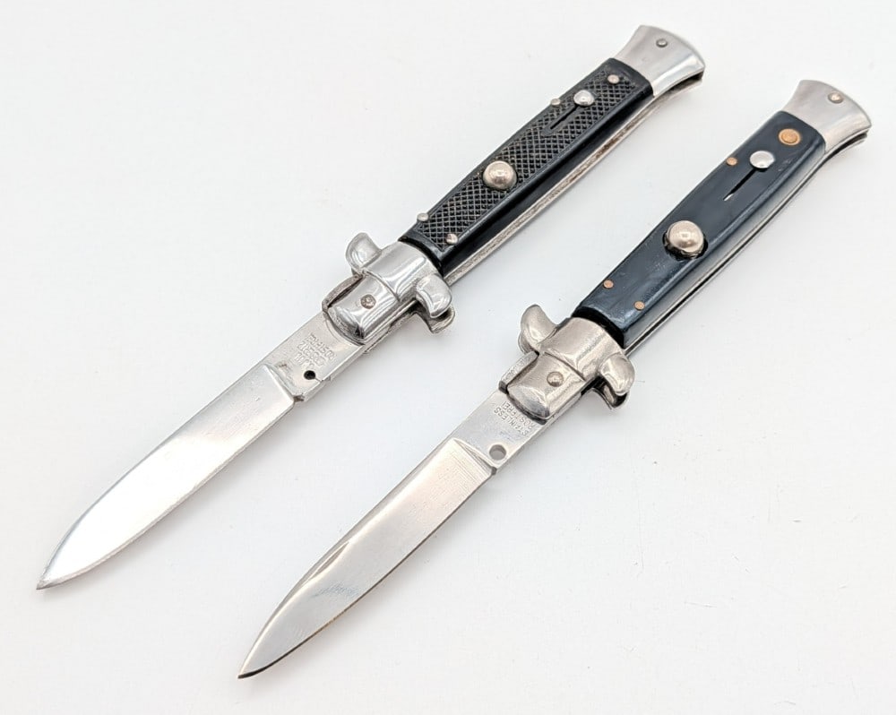 (2) Rostfrei Synth Black Switchblade Knives: Knives are in good condition with scratches on the blades, scuffs on the bolsters, and scratches and wear on the handle scales. The checkered black knife spring does not work. Overall measures 5in whe