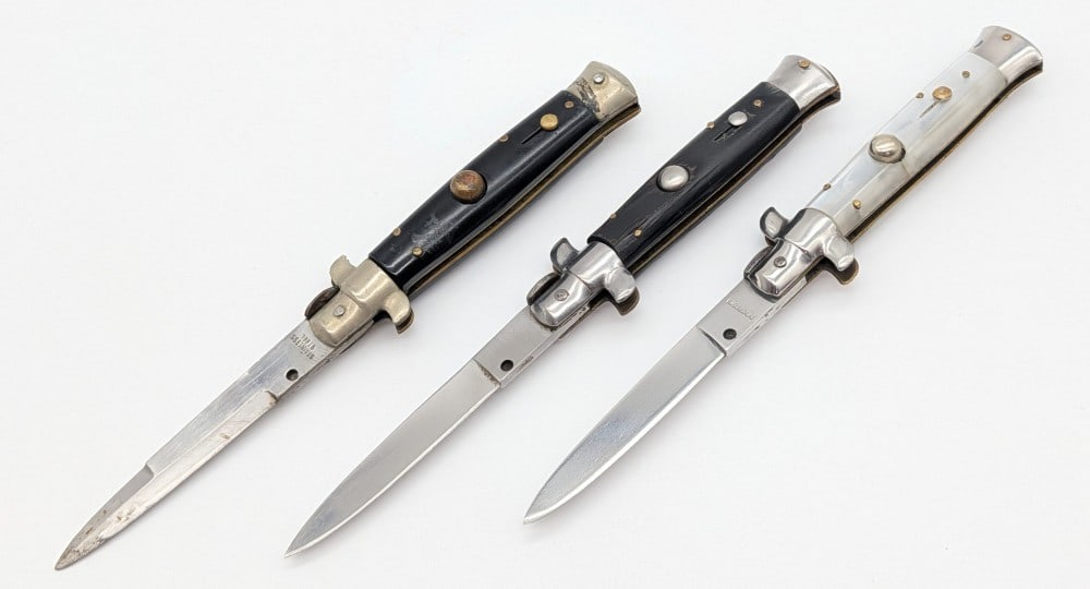 (3) 7in Italian Stiletto Switchblade Knives: Knives are in worn condition with scratches and wear on the blades, scuffs and tarnishing on the bolsters, and other scratches and wear on the handle scales. Overall measures 4in when closed.