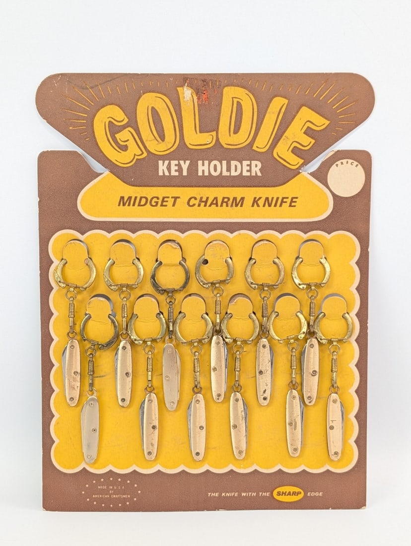 Goldie Midget Charm Knife Store Counter Top Display: Knives are in good condition with tarnishing on the brass from age, and some light dings and staining on the display. Overall measures 8-1/4in wide x 11in tall.