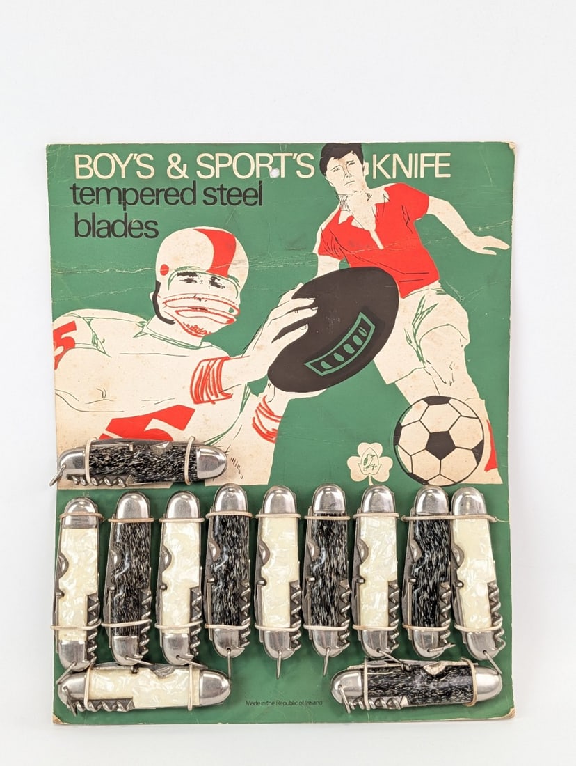 Jowika Boy's & Sport's Camp Utility Knife Counter Top Store Display: Knives are in nice condition with light tarnishing. The display has some damage and wear around the edges, and a large crease on the top edge. Overall measures 10in wide x 12-1/2in tall.