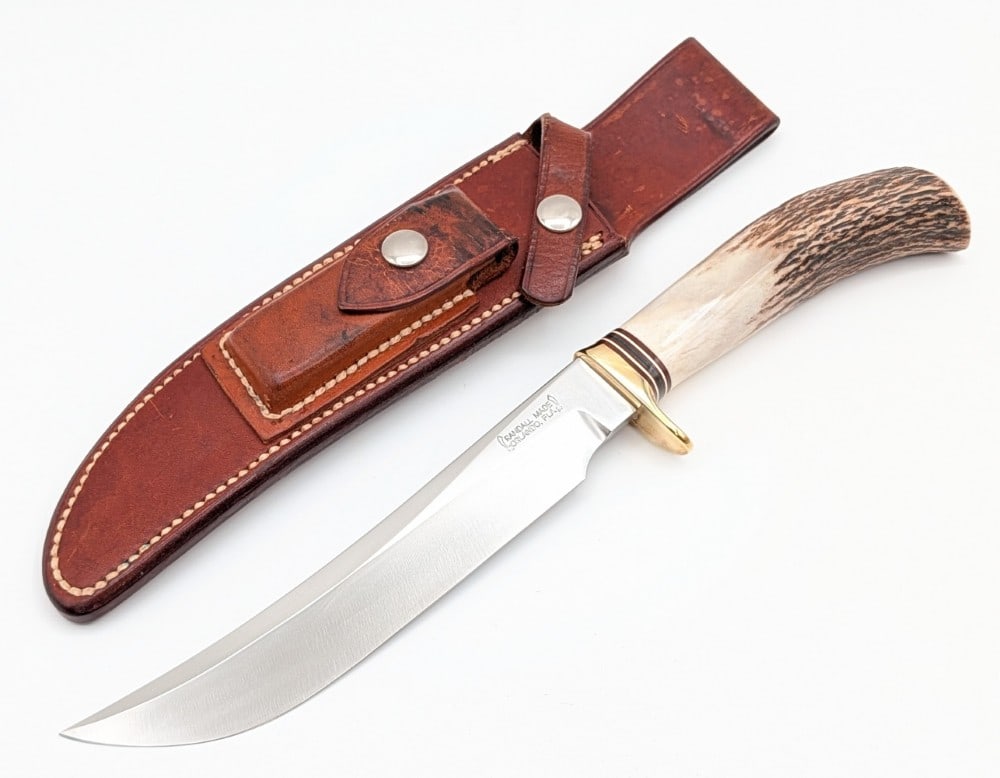 1970's Randall Model 3 7in Stag Hunter w/ Sheath: Features a brass single downturned guard, and a stag handle. Knife is in very nice condition with light scuffs on the blade, and a thin crack on the handle. Blade length measures 6-7/8in and overall 1
