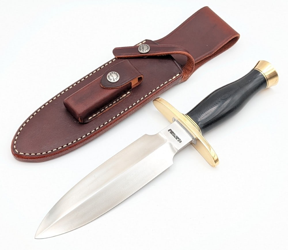 Randall Black Micarta Tom Clinton Special w/ Sheath: Features a double edged stainless steel blade, a brass upturned double oblong guard, a black micarta handle, and a brass butt cap. Knife is in very nice condition with minimal tarnishing from age. Bla