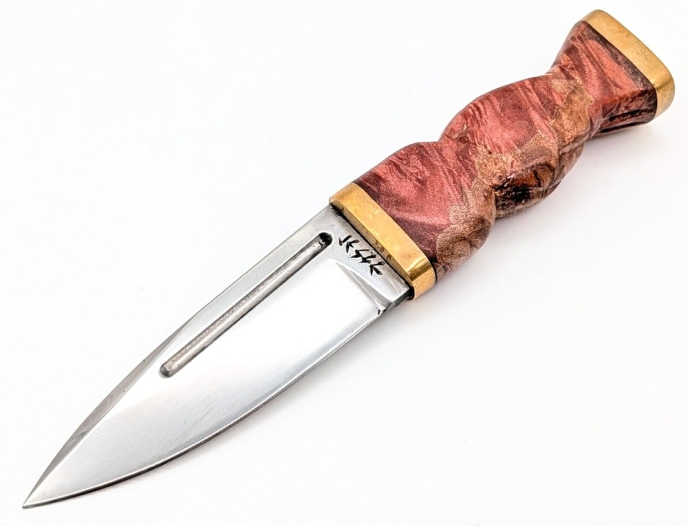 Custom Jesse Nordic Burled Wood Dagger: Maker was a contestant on the show Forged in Fire. Features a drop point fullered blade, a reduced brass guard, a carved burled wood handle, and a brass butt cap with a nut pommel. Knife is in nice co
