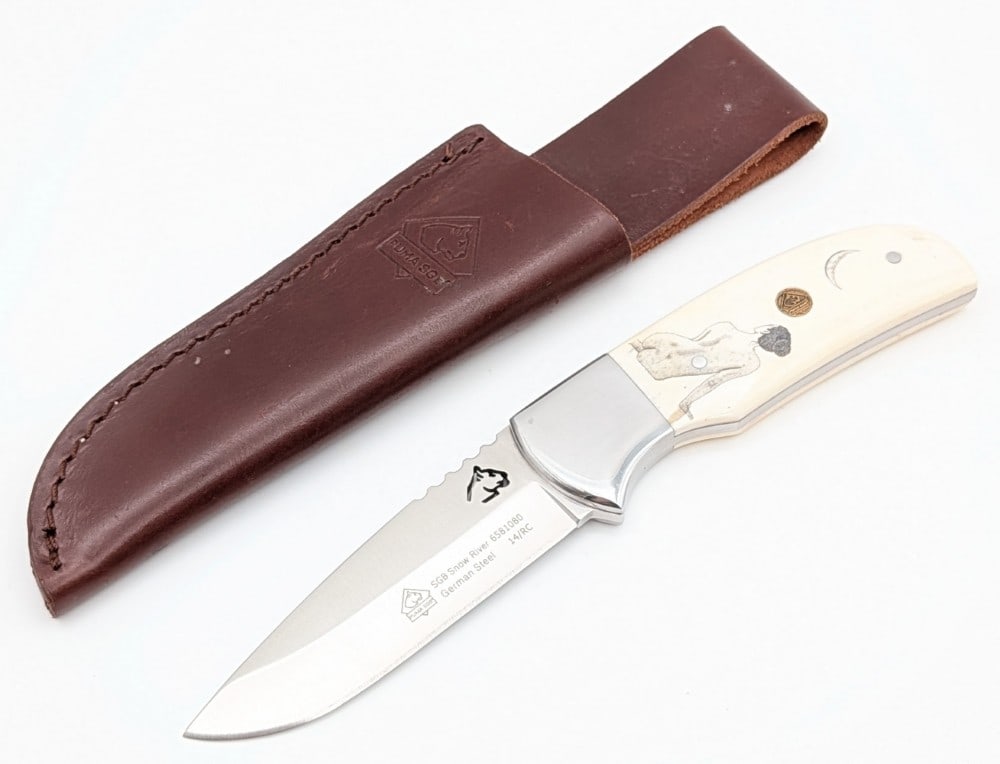 Custom Puma Scrimshaw White Bone Snow River Hunting Knife w/ Sheath: Features a drop point blade with thumb notches, polished steel bolsters, full tang handle construction, and scrimshawed handle scales signed S. Sellers '16. Knife is in very nice condition with some l