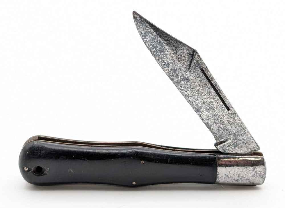 Valley Forge Cutlery Co. Ebony Wood Coke Bottle: Knife is in aged condition with heavy scratches and pitting on the blade, pitting and tarnishing on the bolsters, and general scuffs on the handle scales from use and handling. Overall measures 5-3/8i