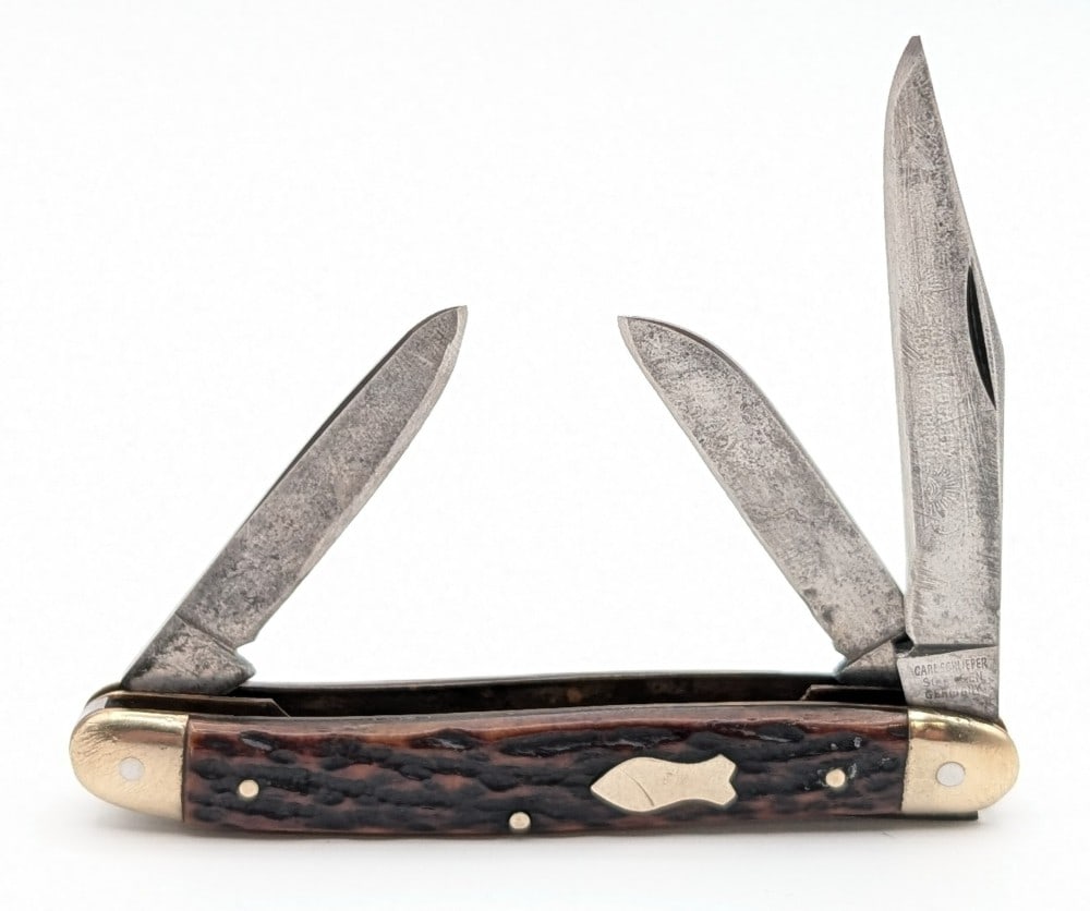 Carl Schlieper Eye Brand Jigged Bone Stockman: Knife is in aged condition with scratches and tarnishing on the blades, scratches on the bolsters, and two chips on the back handle scale. Overall measures 4in when closed.