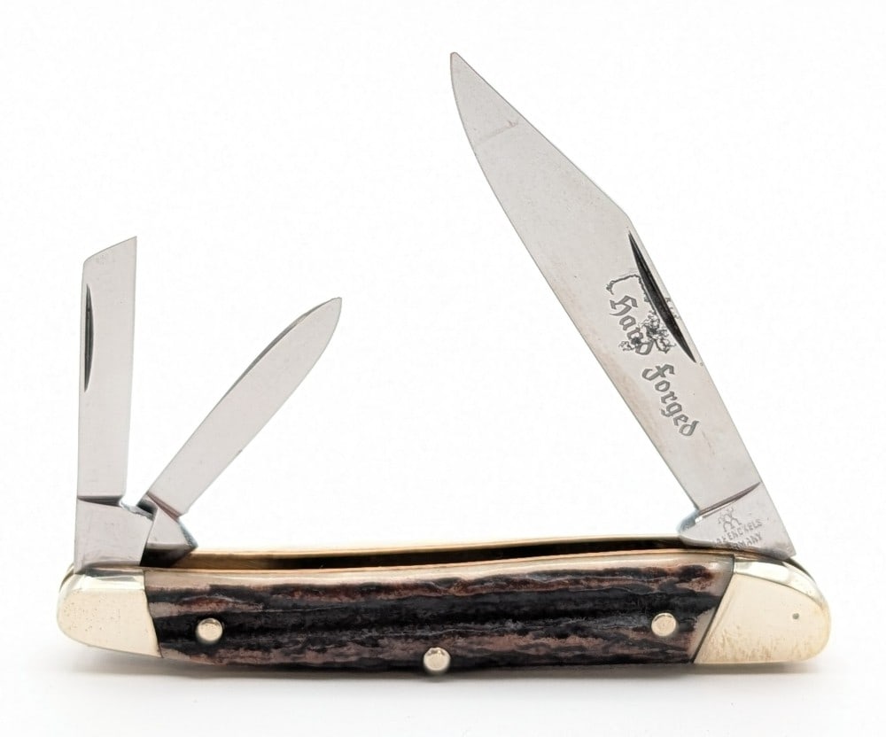 J.A. Henckels Stag Slant Bolster Serpentine Jack Knife 1928: Knife is in nice condition with some scuffs and carbon spots on the blades, and scuffs and tarnishing on the bolsters from handling. Overall measures 3-1/2in when closed.