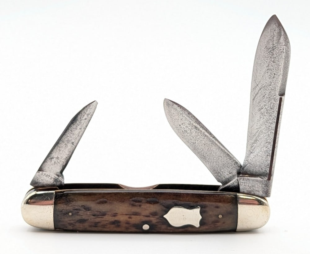 Lawton Cutlery Co. Jigged Bone Long Pull Cigar Jack Knife: Knife is in good aged condition with scratches and material loss on the blades, scuffs on the polished bolsters, and smoothed out handle scales. Overall measures 3-5/8in when closed.