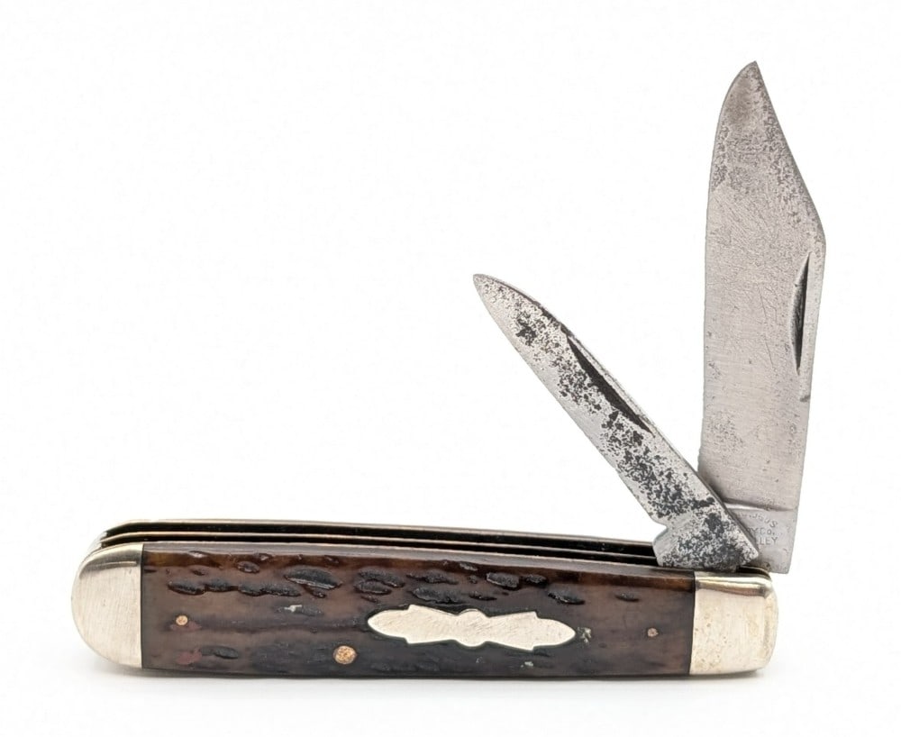 Cattaraugus Cutlery Co. Jigged Bone Uneven Jack Knife: Knife is in good cleaned condition with heavy scratches and material loss on the blades, scratches on the bolsters, and a pin crack on the back handle scale upper pin. Overall measures 3-5/8in when cl
