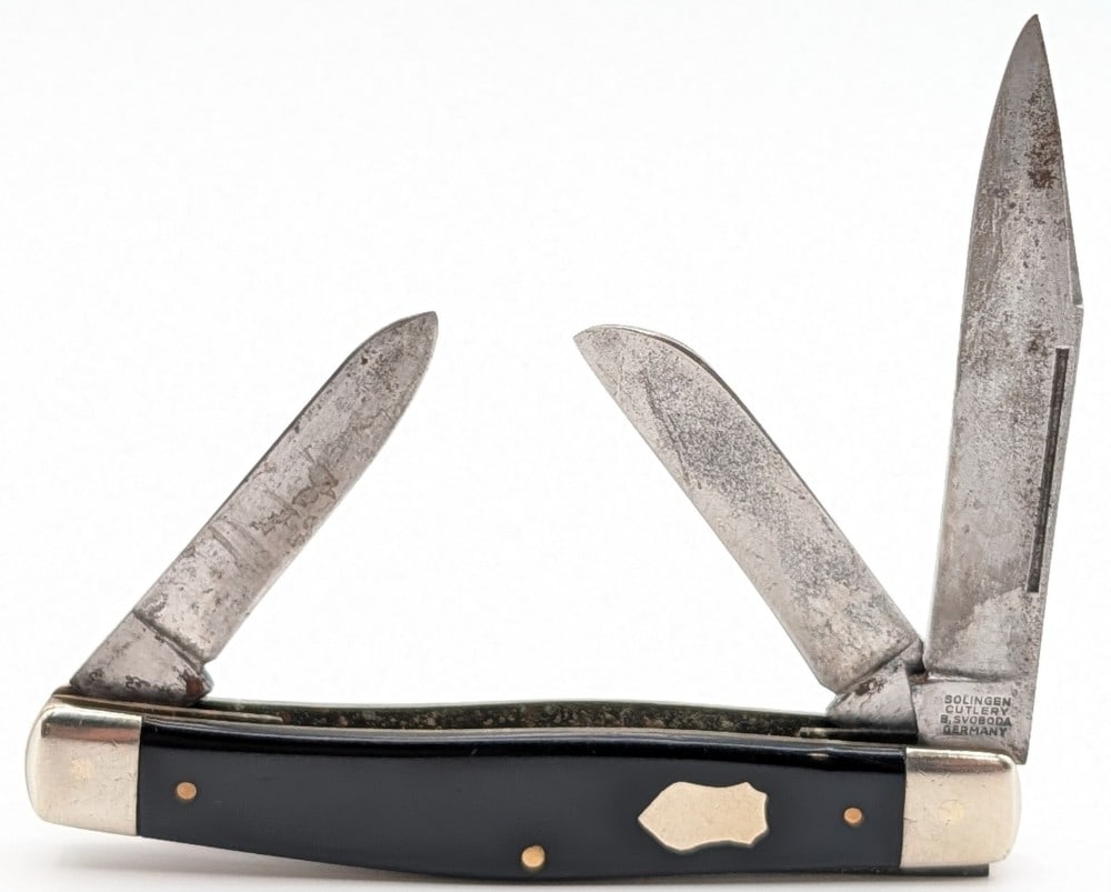 B. Svoboda Solingen Slick Black Long Pull Stockman: Knife is in used condition with scratches and tarnishing on the blades, scratches on the polished bolsters, and general scuffs and wear on the handle scales from use and age. Overall measures 3-7/8in 