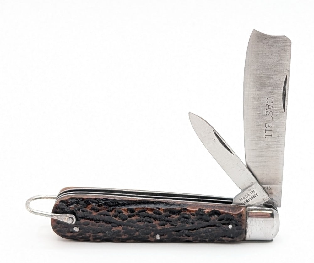 Castell Solingen Jigged Bone Razor Knife: Knife is in very nice condition with light scuffs and tarnishing on the bolsters from age. Overall measures 3-7/8in when closed.