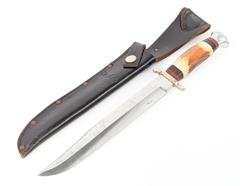 Linder 8in Stag Fighting Bowie Knife w/ Sheath: Features a mirror polished clip point blade, a nickel silver guard, a stag handle with leather spacers, and an aluminum pommel with a brass nut. Knife is in nice condition with tarnishing on the blade