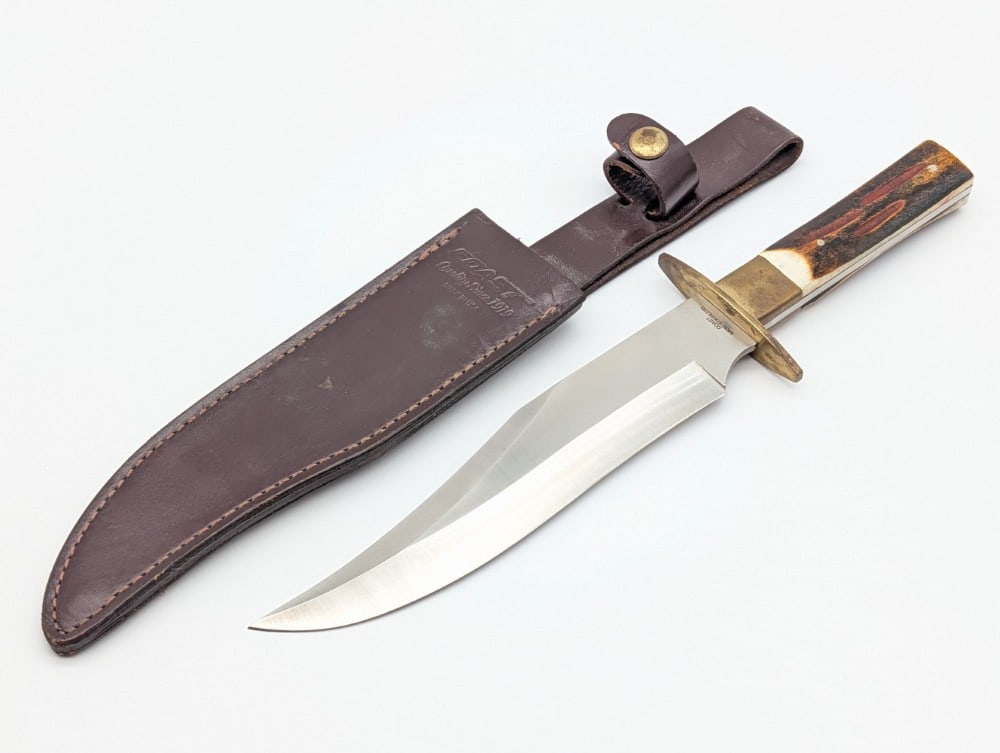 Coast Stag Bowie Knife w/ Sheath: Knife is in good condition with light scuffs and tarnishing on the blade, and tarnishing on the brass. Blade length measures 8-1/4in and overall 13in.