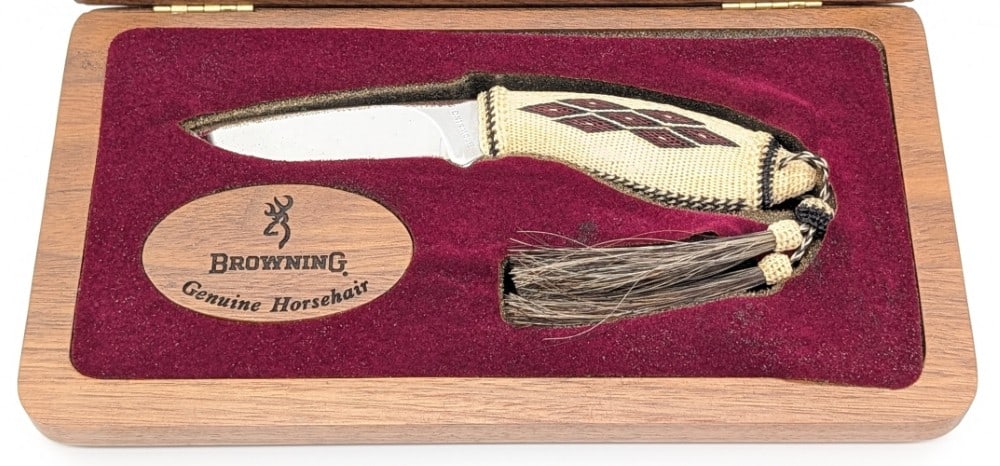 Browning Horsehair Model 382 Drop Point Hunter w/ Case: Features a mirror polished drop point blade, and an intricate woven horse hair handle with two tassels. Knife is in like new condition. Blade length measures 3in and overall 7in.
