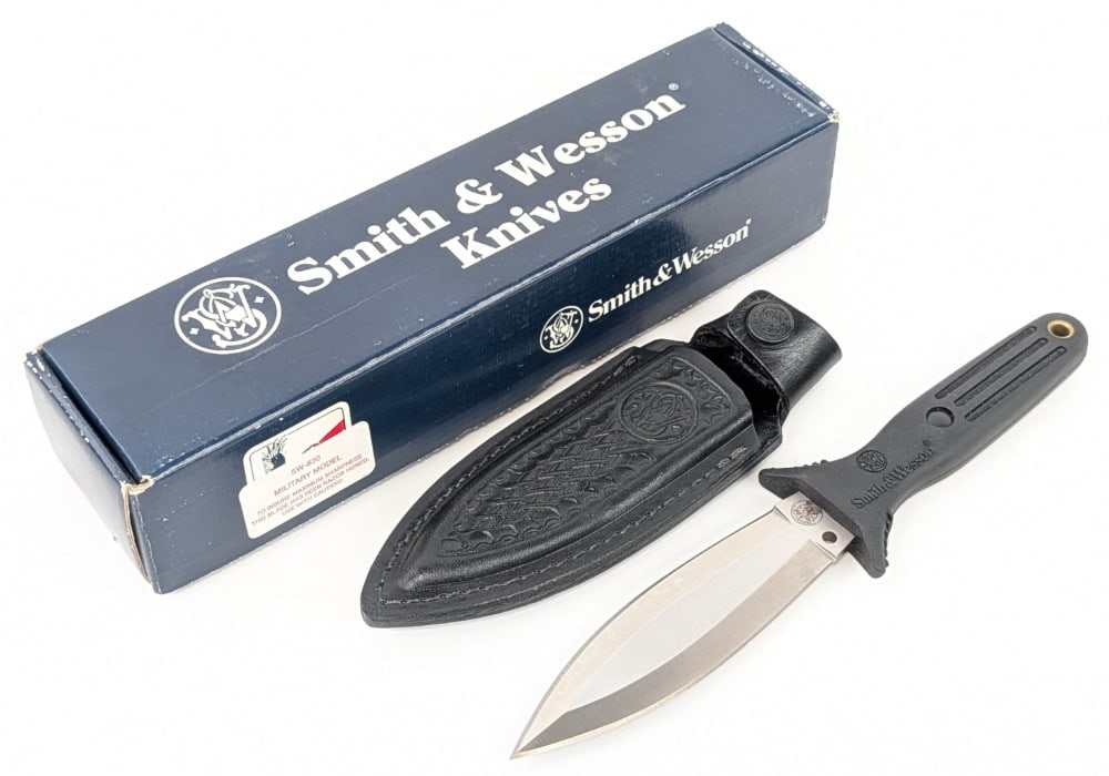 Smith & Wesson Model SW-830 Boot Knife w/ Sheath & Box: Knife is in like new condition. Blade length measures 5in and overall 9-3/4in.