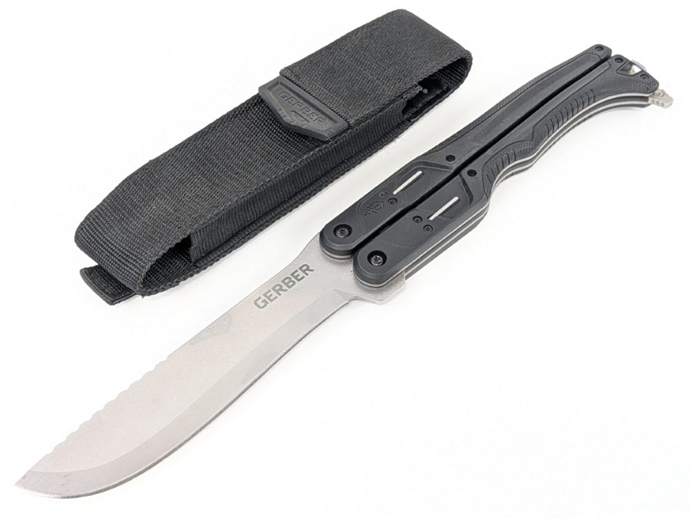 Giant Gerber 15in Balisong Folding Knife w/ Sheath: Features a stonewash finish blade, and black plastic handle scales. Knife is in like new condition. Overall measures 9in when closed.