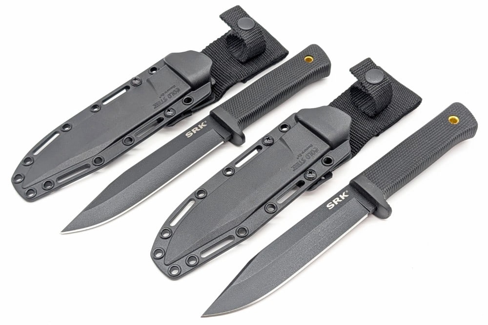 (2) Cold Steel SRK Drop Point Tactical Hunter w/ Sheaths: Feature blade finish drop point blades, and checkered rubber handles with lanyard holes. Knives are in like new condition. Blade length measures 6in and overall 10-3/4in.