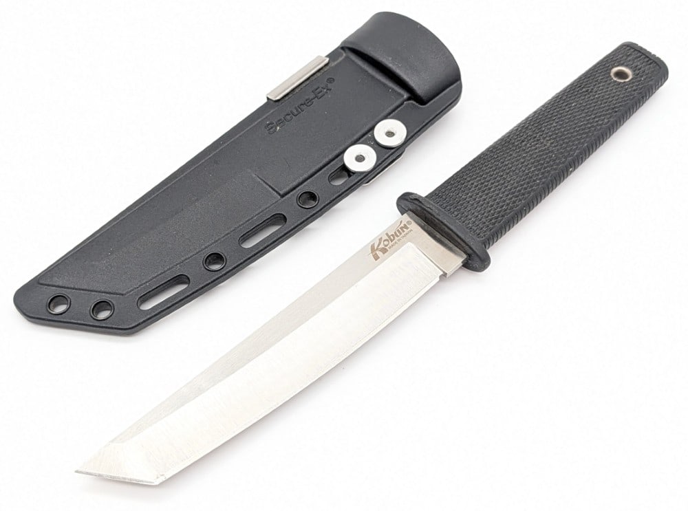 Cold Steel Kobun Tanto Fixed Blade Knife w/ Sheath: Features a curved tanto blade, and a checkered rubber handle. Knife is in very nice condition with light scuffs on the blade, and light wear on the rubber handle. Blade length measures 5-1/4in and ove