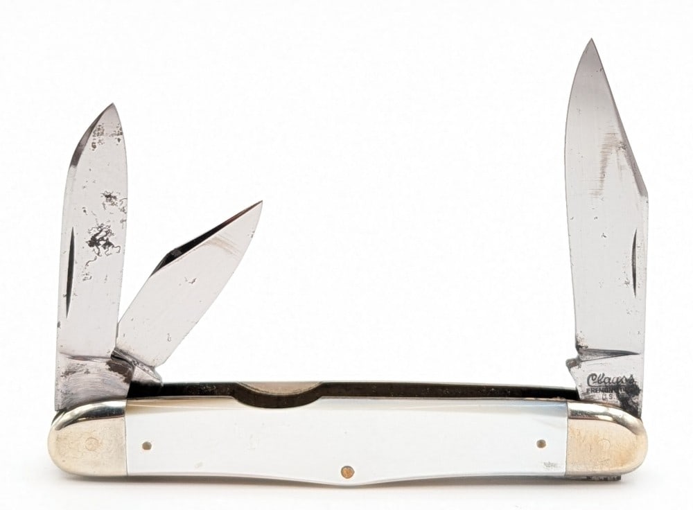 Clauss Mother of Pearl Humpback Stockman 33: Knife is in good aged condition with some scratches and rust spots on the blades, scuffs and tarnishing on the bolsters, and nice handle scales. Overall measures 4in when closed.