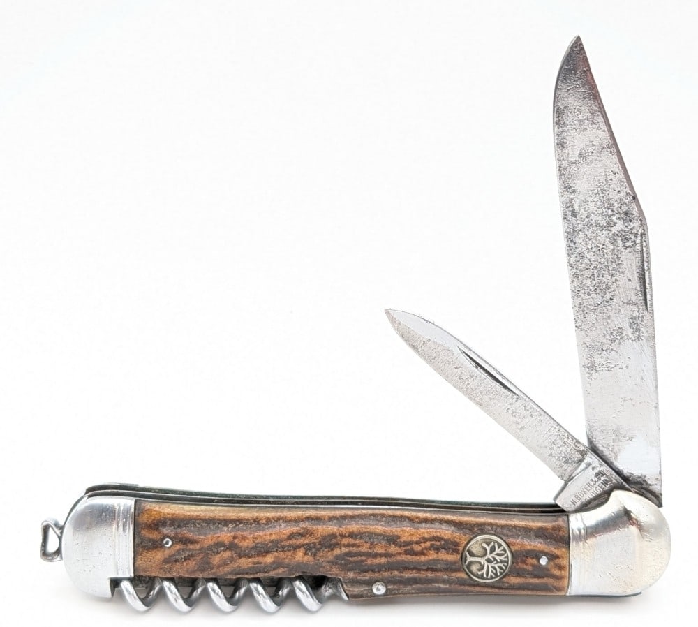 H. Boker & Co. Stag Copperhead Utility Knife: Knife is in aged condition with pitting and scratches on the blades, scratches and dings on the bolsters, and nice handle scales. Overall measures 5-1/4in when closed.