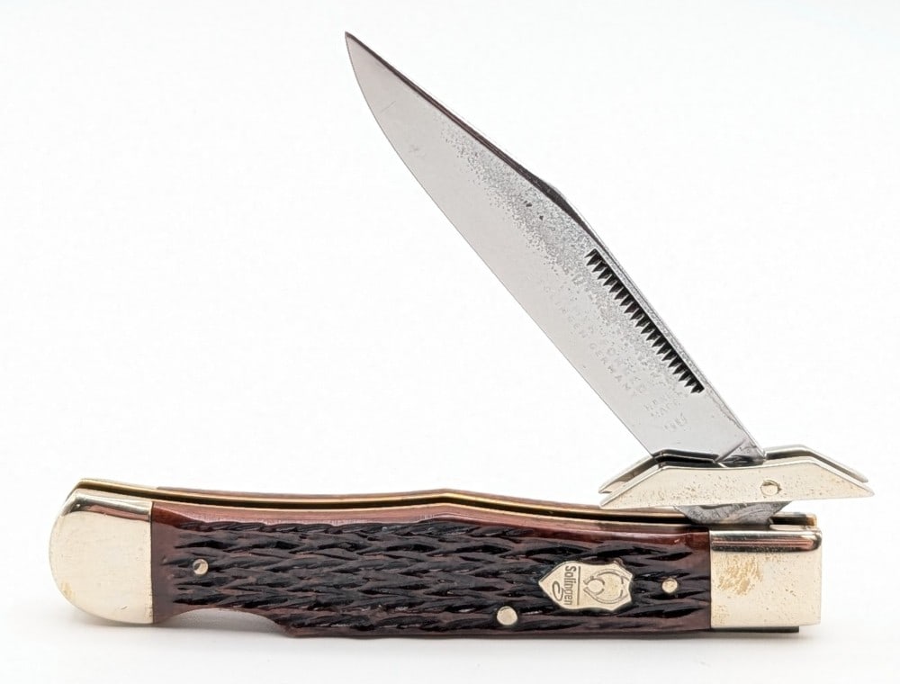 Buck Creek Crows Foot Jigged Bone Swing Guard Lock Back Cheetah: Knife is in nice condition with some tarnishing on the blade, scuffs and tarnishing on the bolsters, and nice handle scales. Overall measures 4-1/4in when closed.