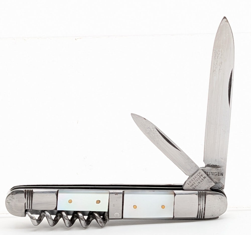 Friedrich Hartkopf Mother of Pearl Utility Knife: Knife is in good condition with scuffs and tarnishing on the bolsters from handling and age. Overall measures 3-1/2in when closed.