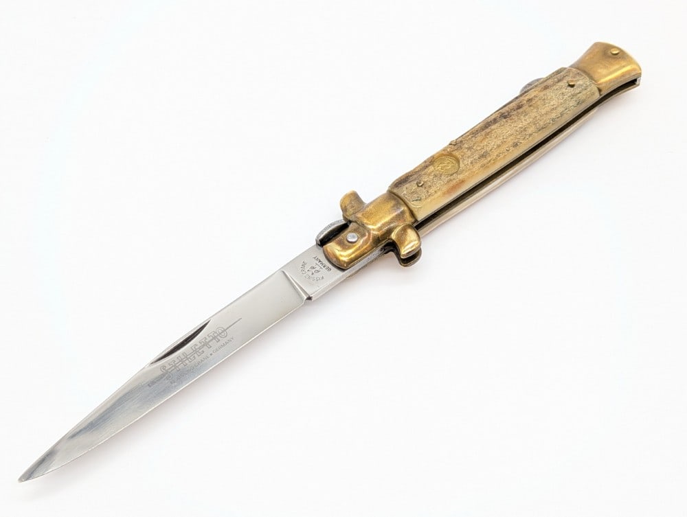 Kissing Crane Stag Stiletto Lock Back Knife: Knife is in very nice condition with tarnishing on the brass from age. Overall measures 4-7/8in when closed.