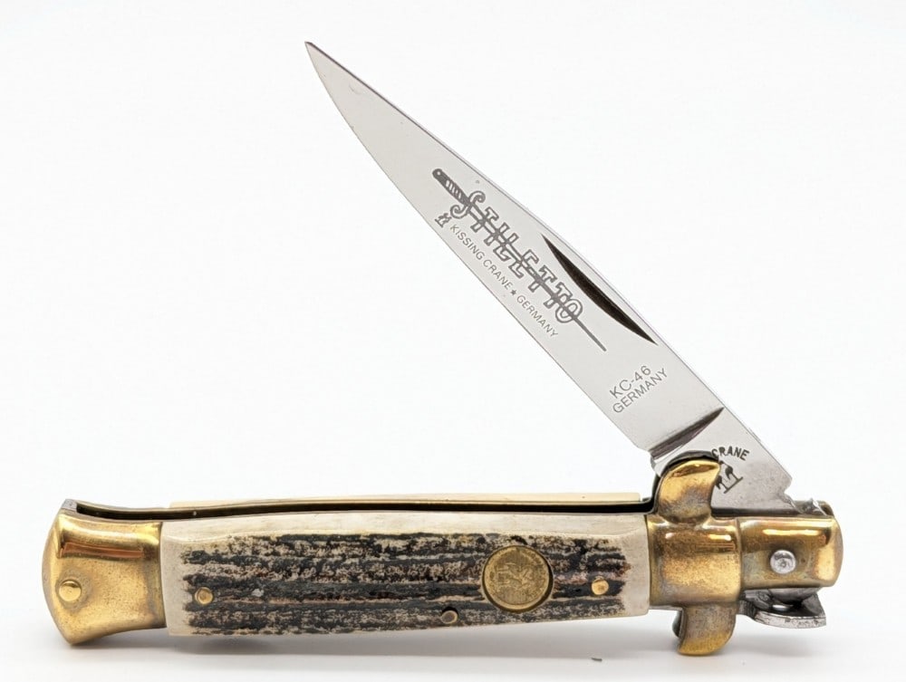 Kissing Crane Stag Stiletto Lock Back Knife: Knife is in very nice condition with tarnishing on the brass from age. Overall measures 3-7/8in when closed.