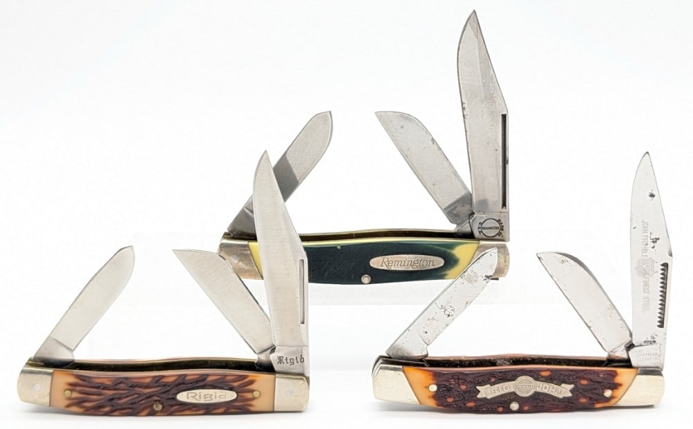 John Primble, Remington, & Rigid Jigged Delrin Large Stockmans: Knives are in good condition with light scratches and tarnishing from handling and age. Largest overall measures 4-1/4in when closed.