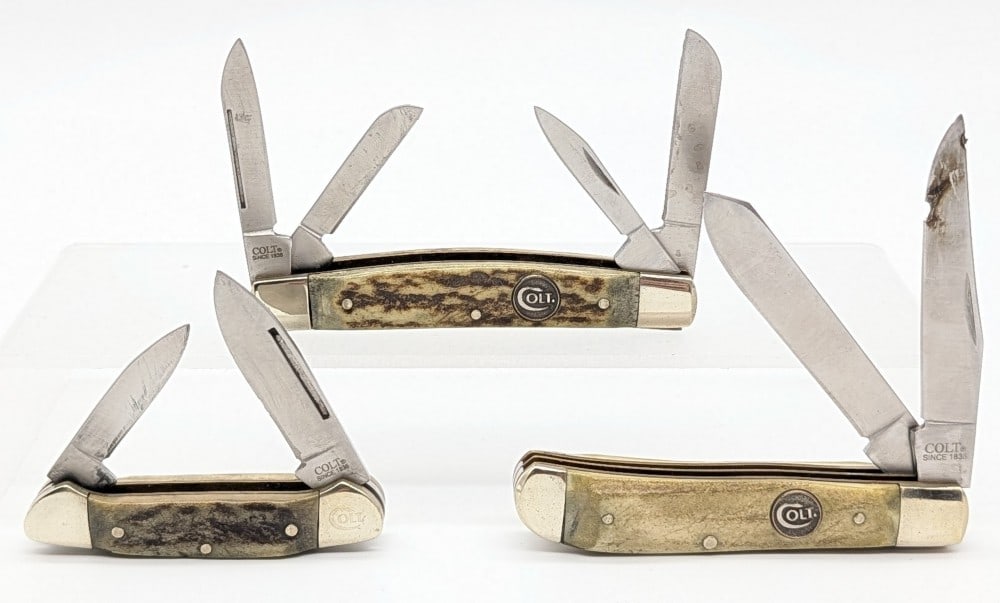 Colt Stag Trapper, Stockman, & Canoe Knife: Knives are in fair used condition with scuffs and tarnishing on the bolsters from use. Largest overall measures 3-5/8in when closed.