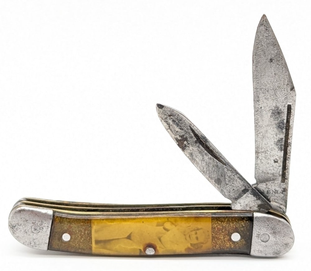Colonial High Art Celluloid Peanut: Knife is in aged condition with scratches and carbon spots on the blade, scratches and tarnishing on the bolsters, and damage to the handle scales. Overall measures 3-1/8in when closed.
