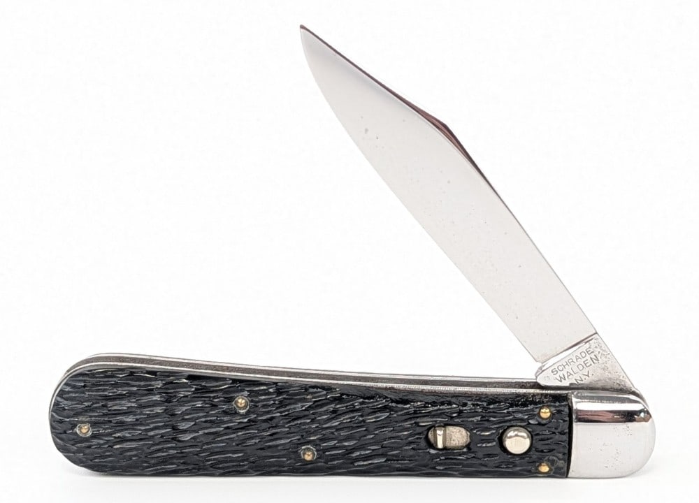 Schrade Walden Rough Black Press Button Switchblade Knife 154: Knife is in great condition with some light scuffs and traces of pits on the polished blade, minimal scuffs on the polished bolsters, and nice handle scales. Spring is strong with a tiny bit of