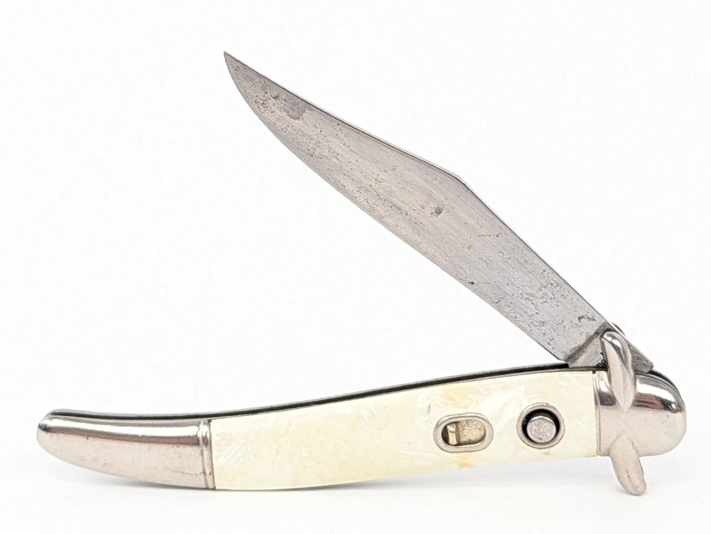 Imperial Faux Pearl Bowtie Toothpick Switchblade Knife: Knife is in used condition with scratches on the blade, and scuffs on the bolsters from use and handling. Overall measures 4-1/4in when closed.