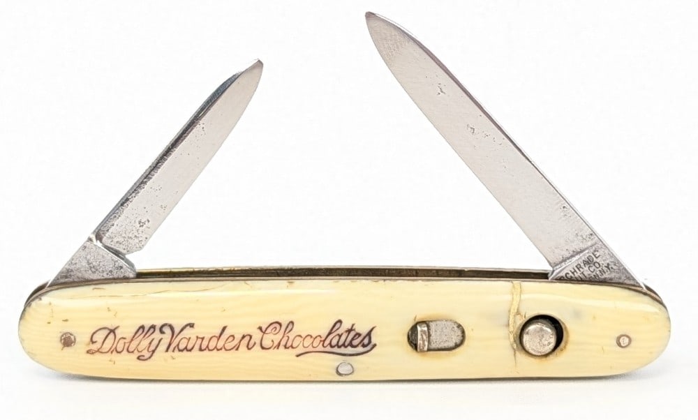 Schrade Cut Co. Dolly Varden Chocolates Double Switchblade Knife: Knife is in fair aged condition with material loss and pits on the polished blades, and a crack on the front handle scales with other general wear. Springs are strong, but the secondary blade does not