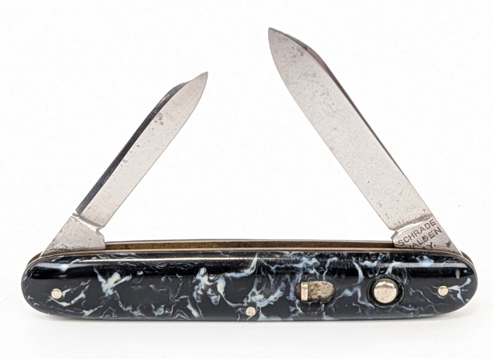 Schrade Walden Marbled Synth Black Double Switchblade Knife: Knife is in good used condition with scratches and some carbon spots on the blades, and general scuffs and wear on the handle scales. Springs are strong and blades lock tight when open. Overall measur