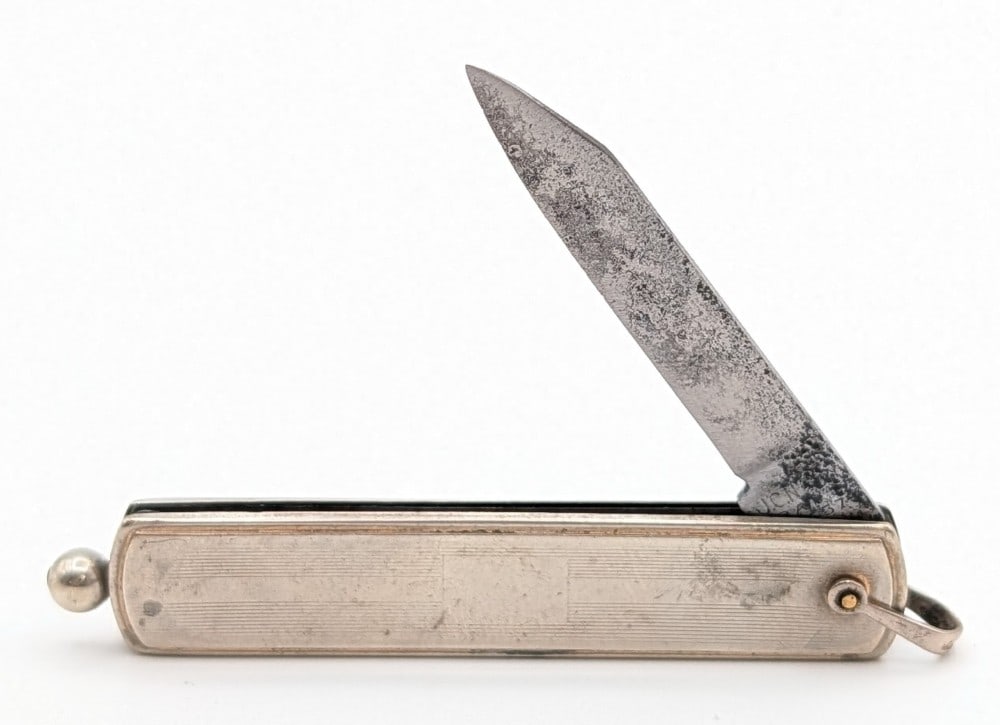 J.C.N. Co. Metal Pull Release Switchblade Knife: Knife is in aged condition with heavy pitting on the blade, and scratches on the handle. Overall measures 2-7/8in when closed.