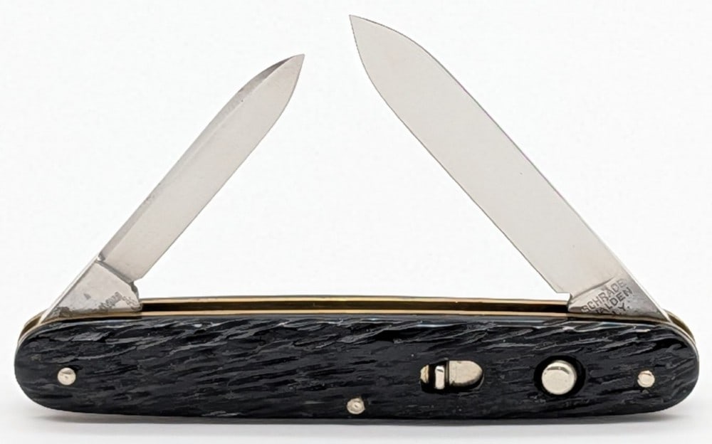 Schrade Walden Rough Black Double Switchblade Knife: Knife is in mint condition with little to no wear from handling. Blade springs are strong and lock tight. Overall measures 3-3/8in when closed.