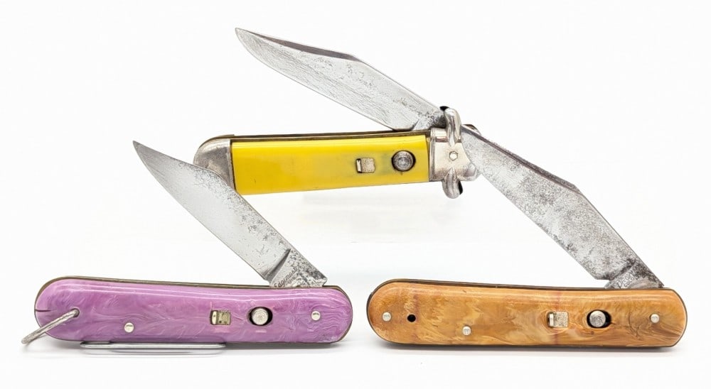 Proto, Edgemaster, & Shur-Snap Press Button Switchblade Knives: Knives are in fair condition with scratches and tarnishing on the blades, and scratches and general wear on the handle scales. The Shur-Snap blade does not lock open. Overall measures 4in when closed.